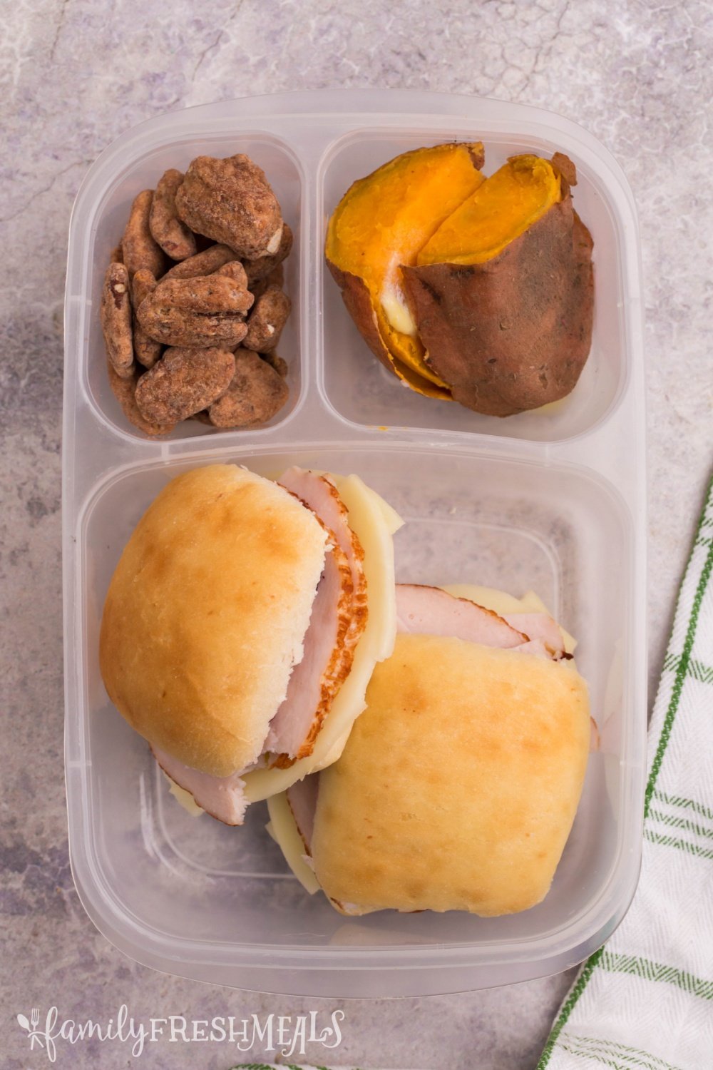 lunchbox packed with 2 mini turkey sliders, sweet potatoes and pecans