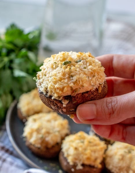 hand holding a stuffed mushrooms