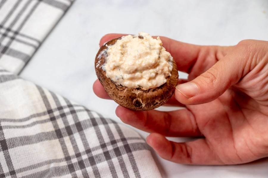 hand holding one stuffed mushroom