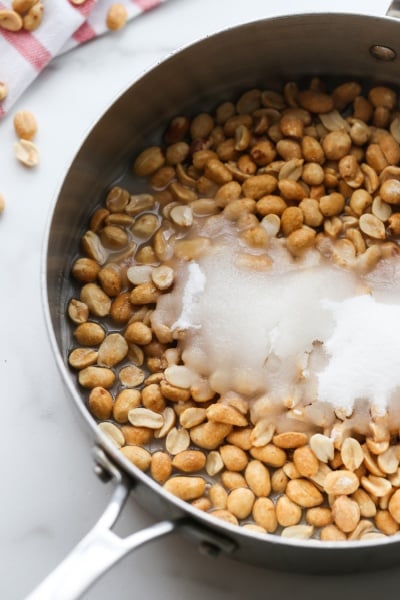 adding peanuts, sugar want water to cooking pan