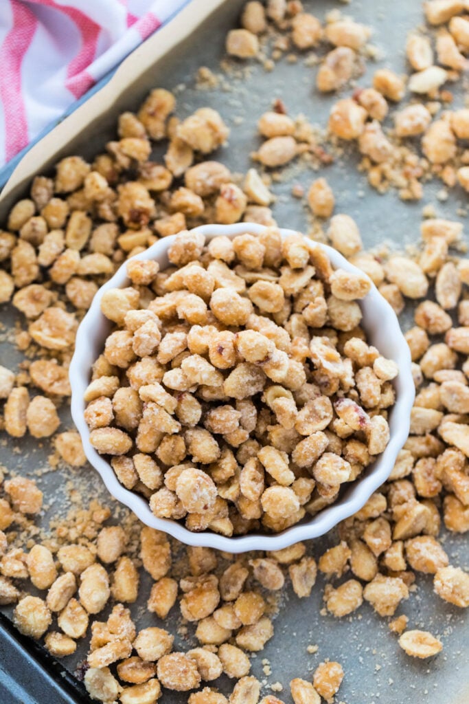 candied sugar peanuts in a bowl, sitting on a baking sheet