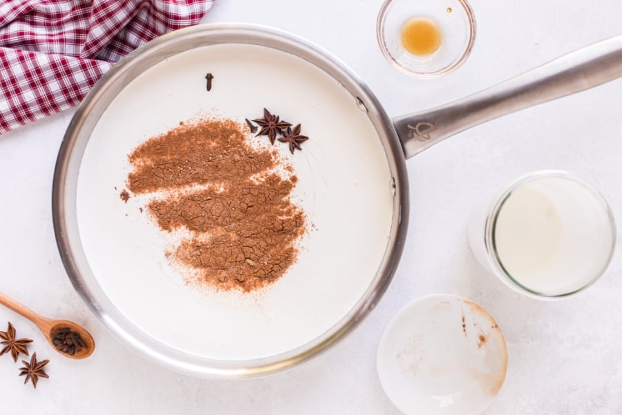 milk and heavy cream to a large saucepan with the cinnamon, nutmeg, cloves, anise, and salt into sauce pan