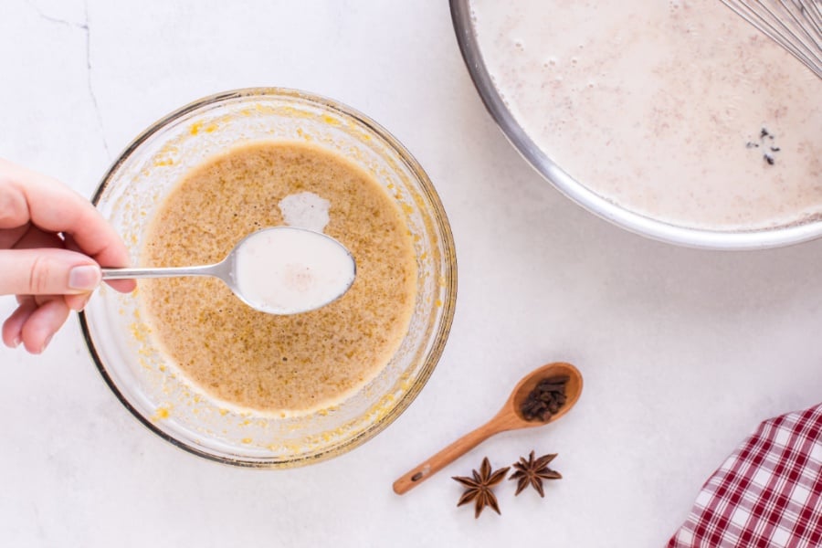 adding a spoon of milk to egg mixture