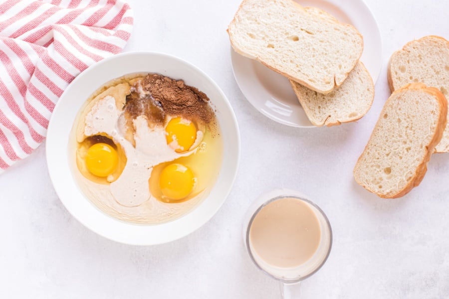 eggs, eggnog, cinnamon, nutmeg, and brown sugar in a bowl