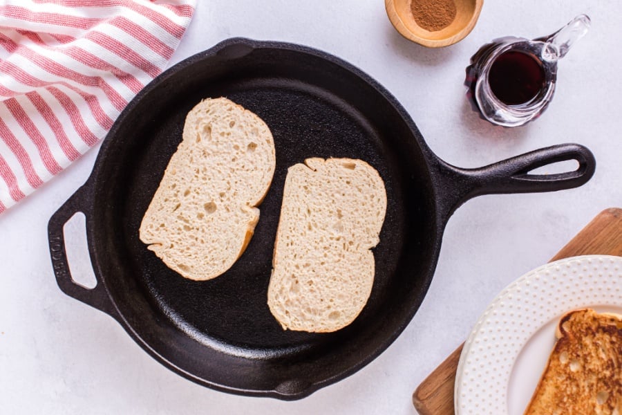 french toast cooking in a cast iron pan
