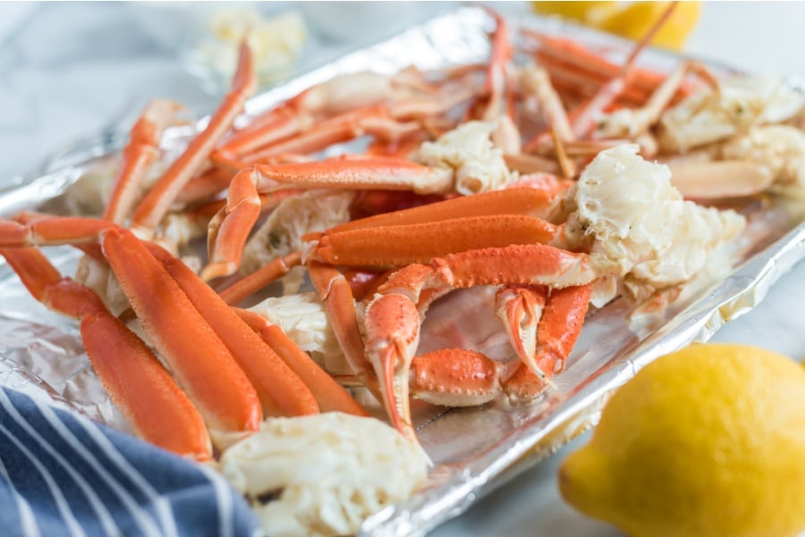 crab leg clusters on a baking sheet