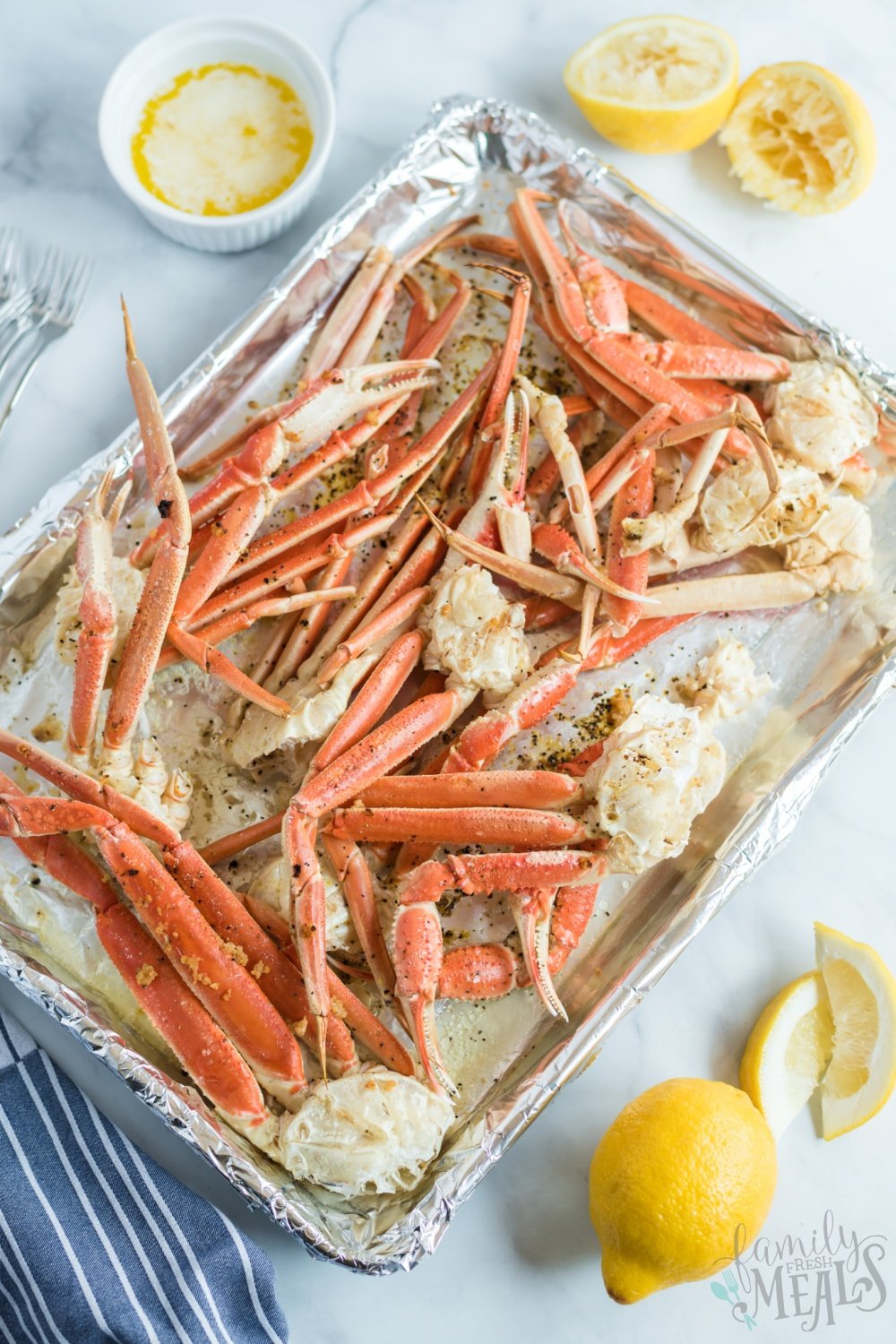 crab leg clusters on a baking sheet