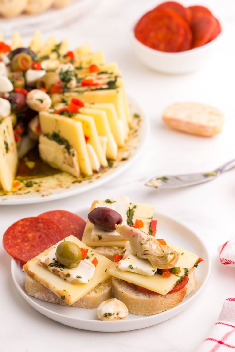 small serving of the marinated cheese ring on a white plate