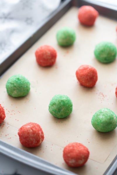 red and green butter cookies on a baking sheet