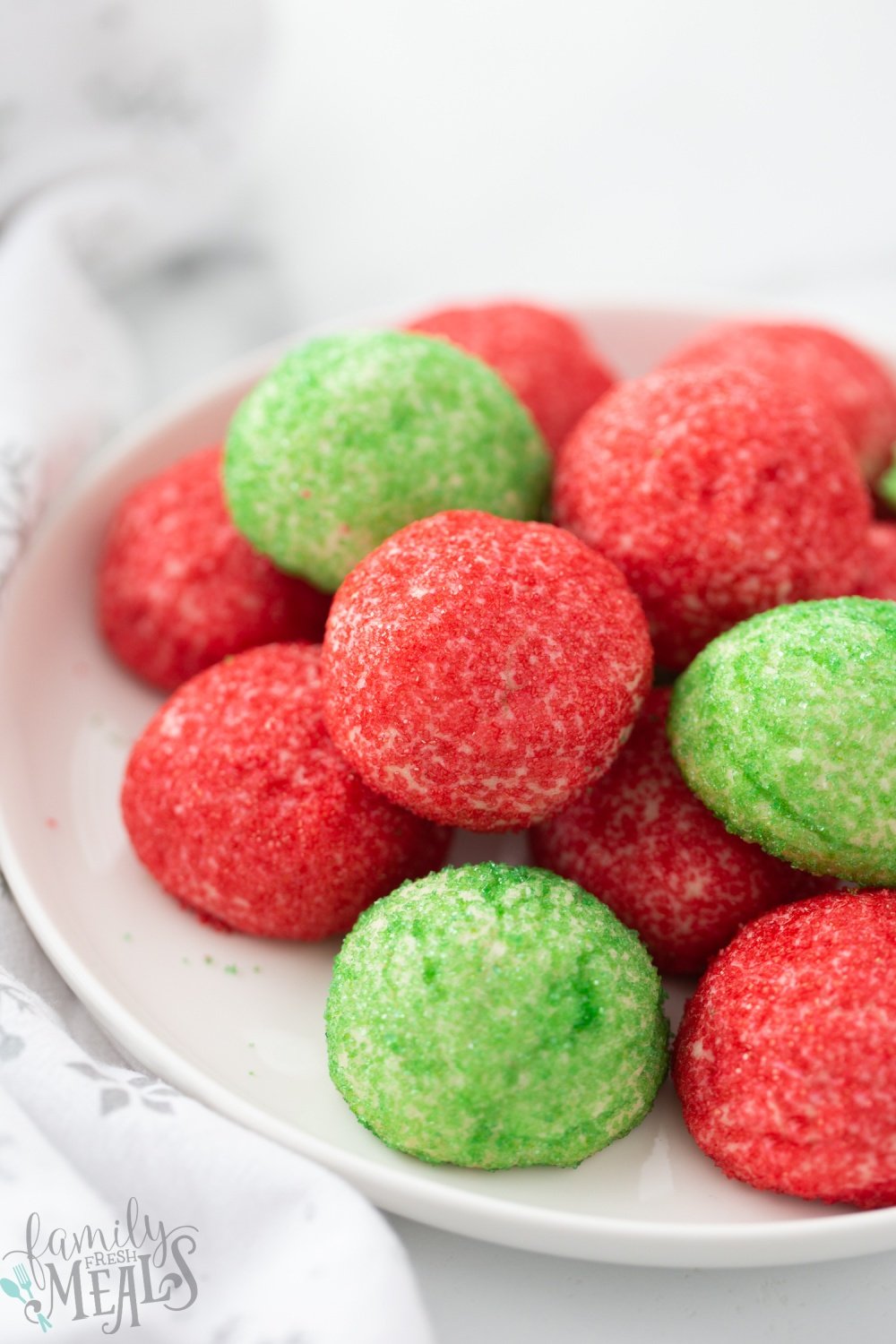 Red and Green Butter Cookies stacked on a plate