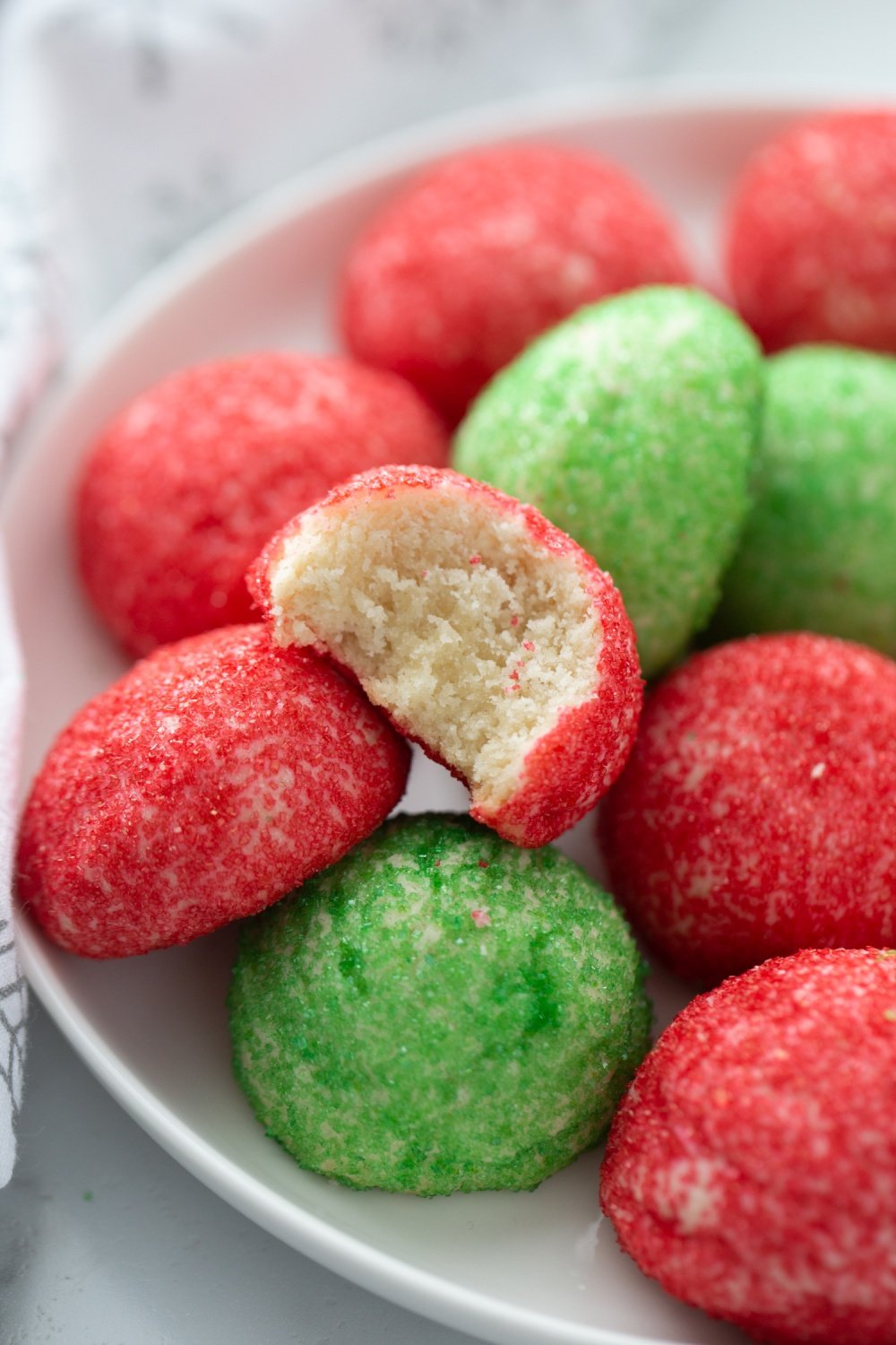 Red and Green Butter Cookies stacked on a plate