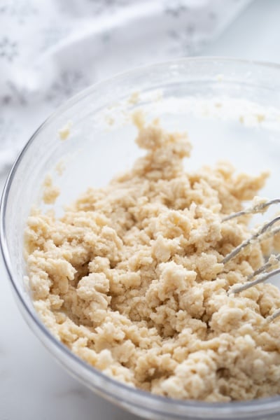 cookie dough being mixing with hand mixer