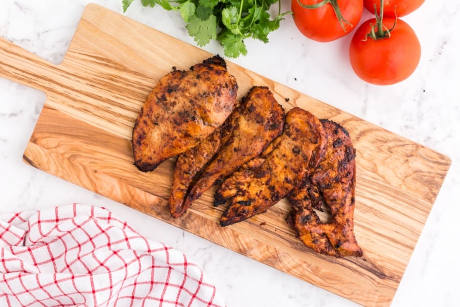 cooked chicken breasts on a cutting board