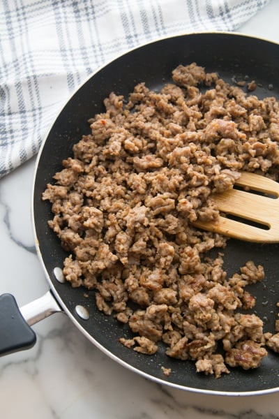 sausage browning in a pan