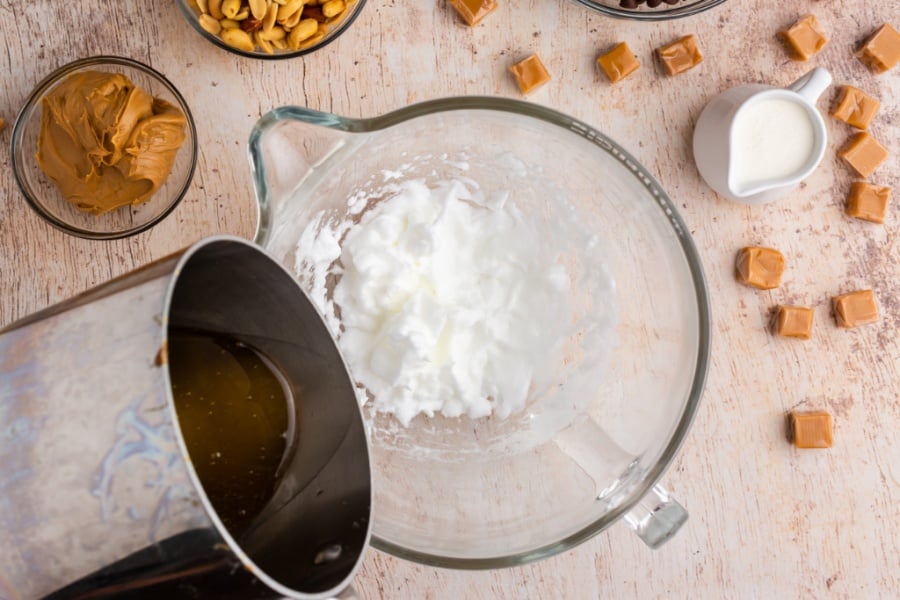 adding sugar mixture to egg white foam