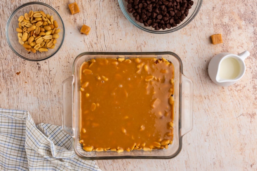 melted caramel added on top of peanuts