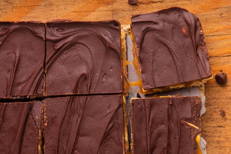 homemade snickers bars being cut into squares