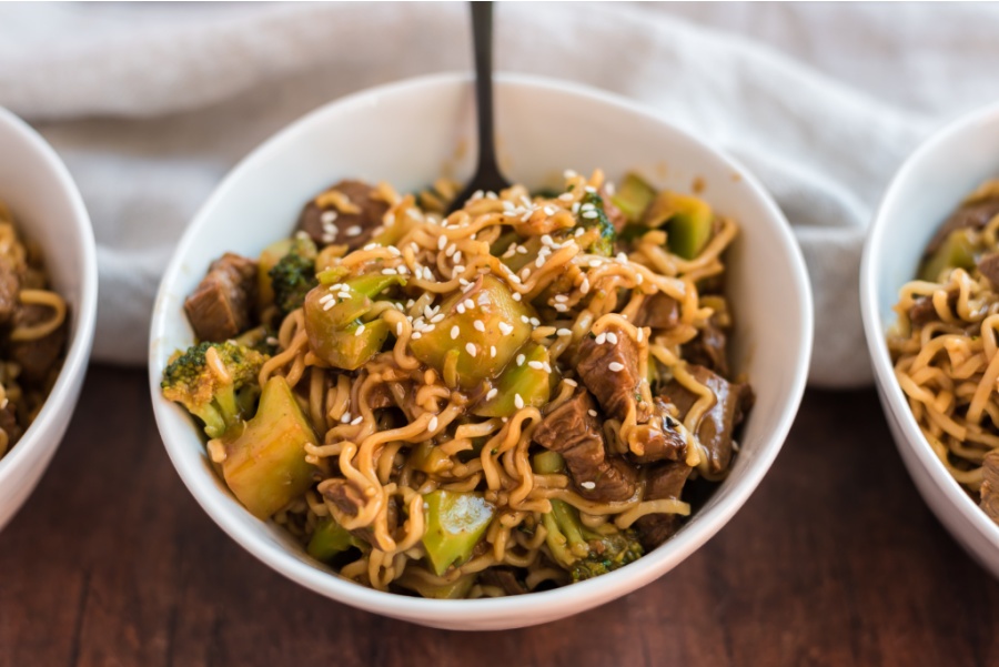 Take-Out Beef and Broccoli Ramen Noodles in bowls with a fork in one