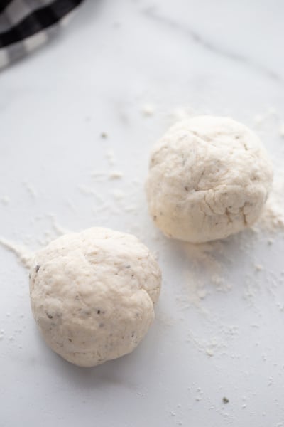 two balls of dough on parchment paper