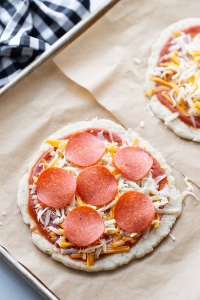 small pizzas on a baking sheet