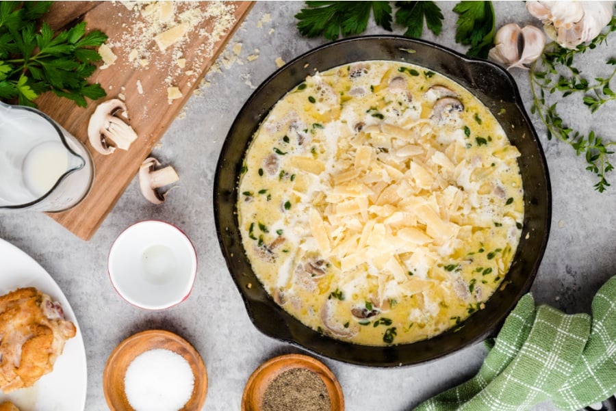 cream, parmesan cheese, salt and pepper added to the pan with mushrooms