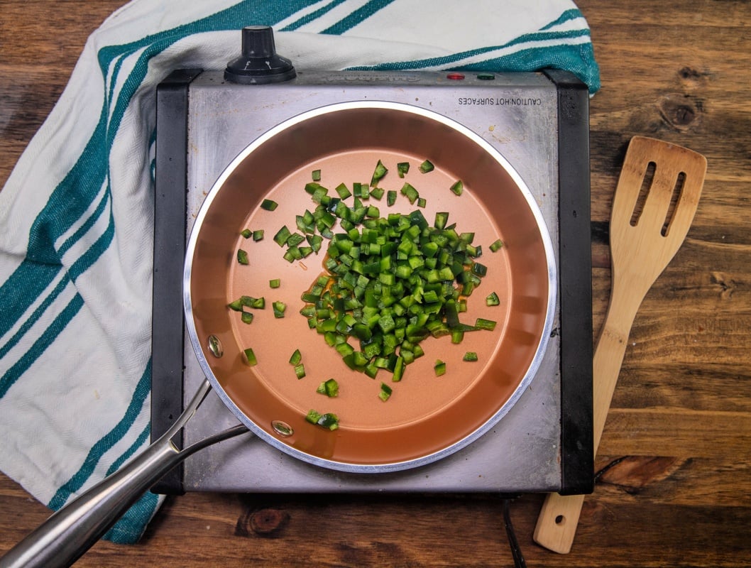 diced jalapeno in a frying pan