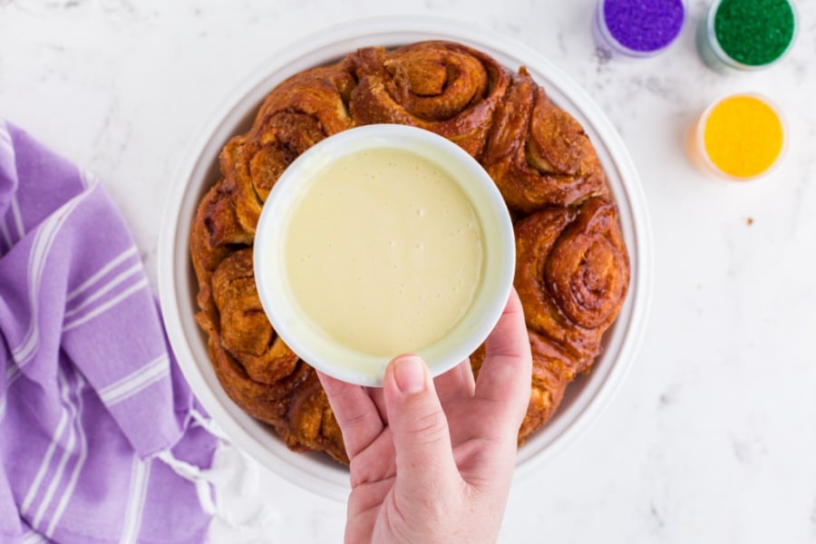 frosted in a bowl, held over cake