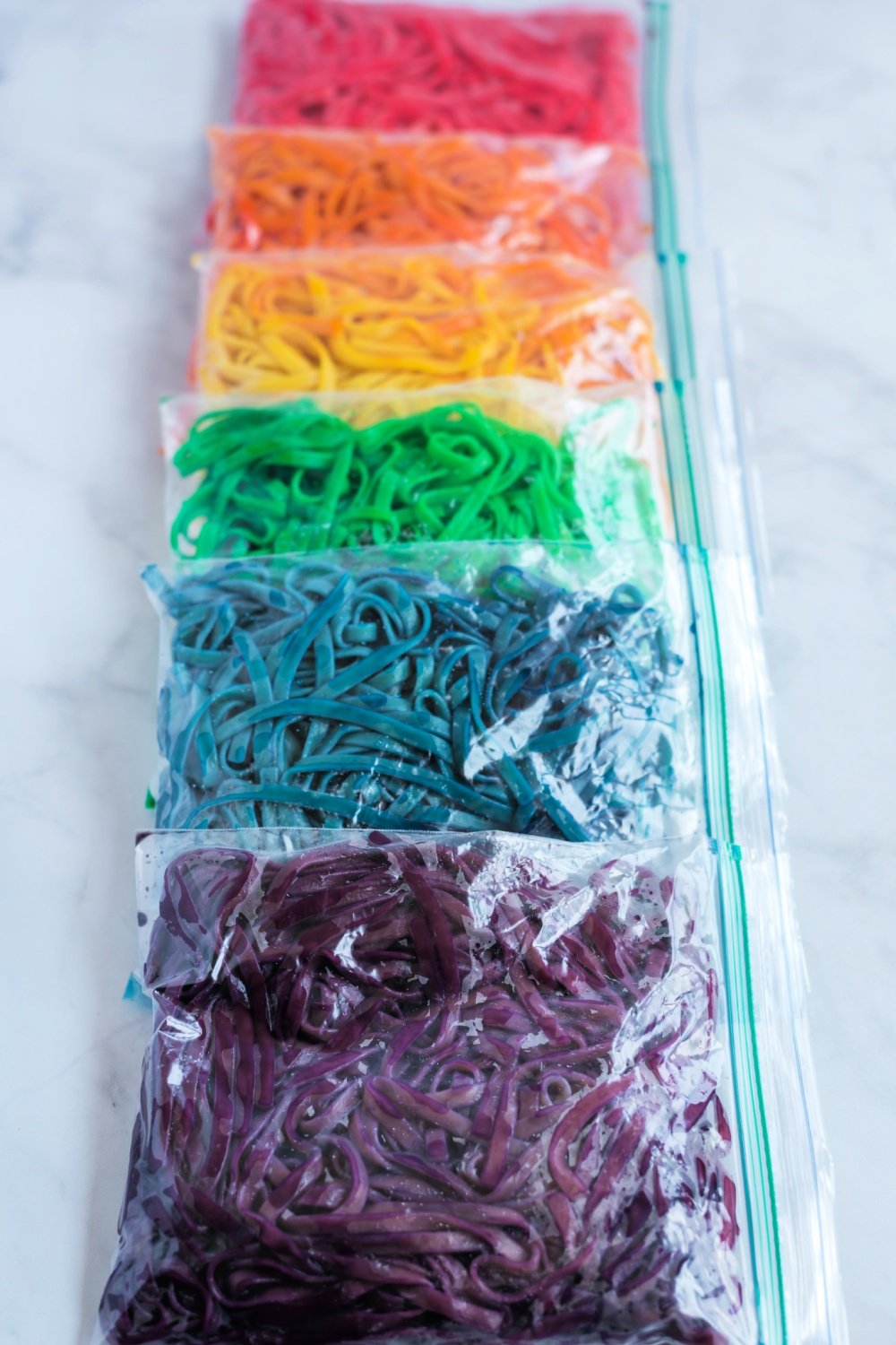 different color noodles in ziplock bags