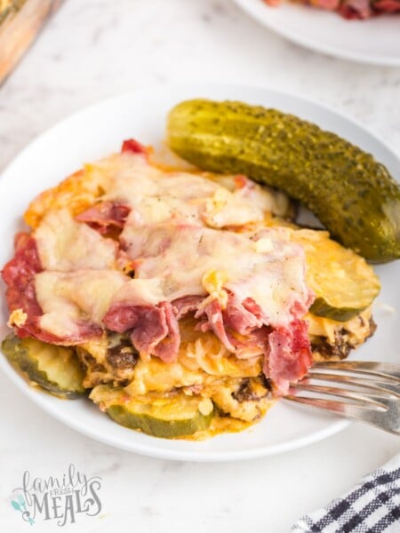 piece of reuben casserole on a plate with a pickle
