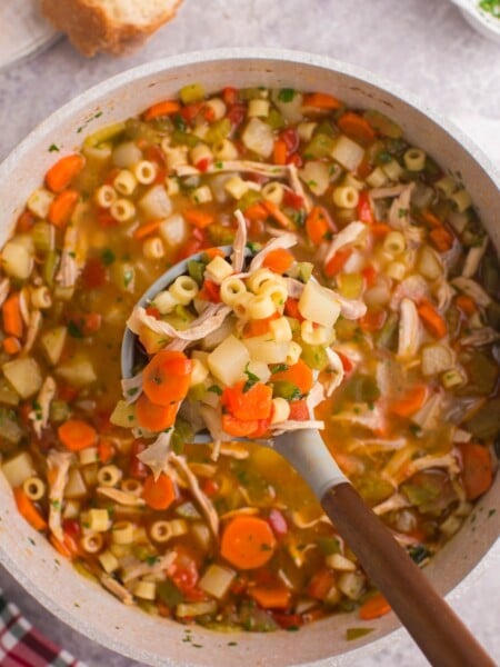 pot of soup with spoon scooping up some