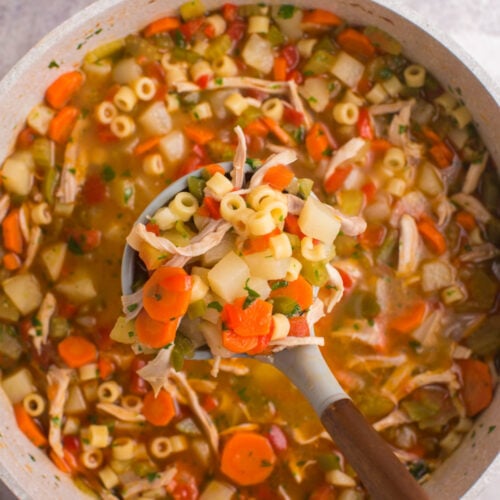 pot of soup with spoon scooping up some