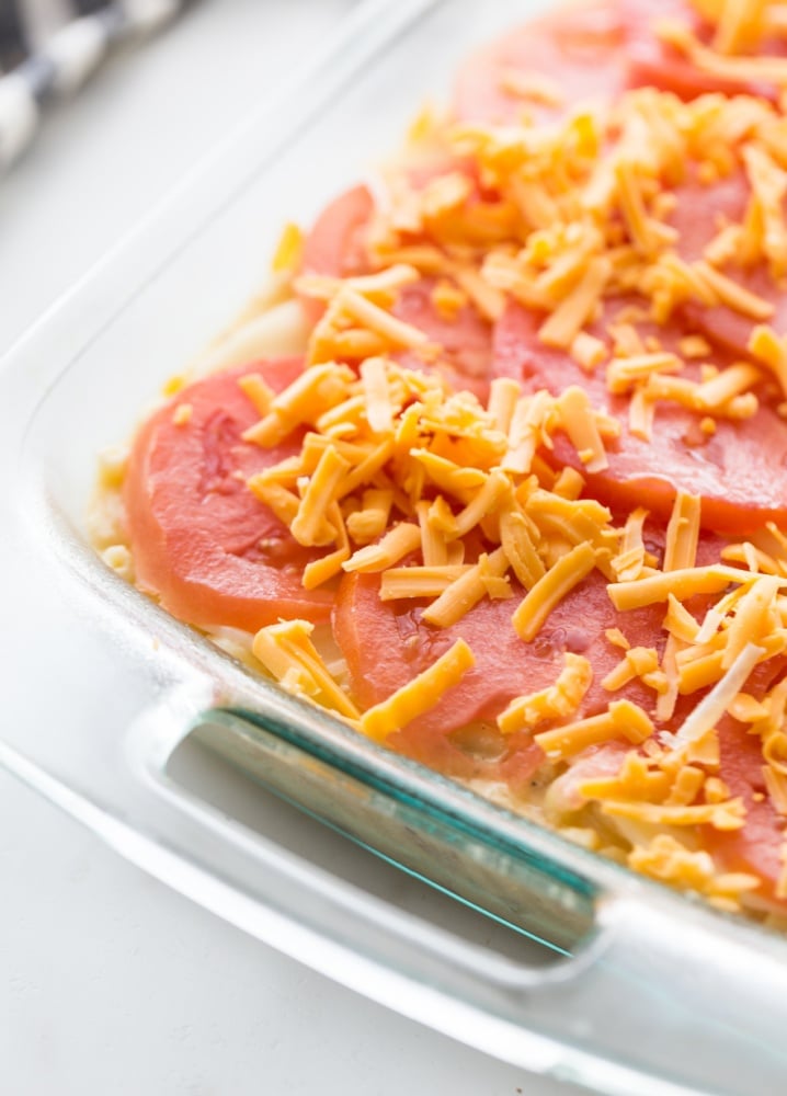 sliced tomatoes and shredded cheese added to top of the casserole