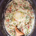 Crockpot Colcannon Potatoes in a slow cooker with a wooden spoon