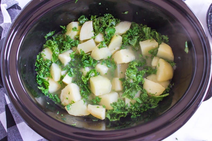 chopped kale adding into slow cooker