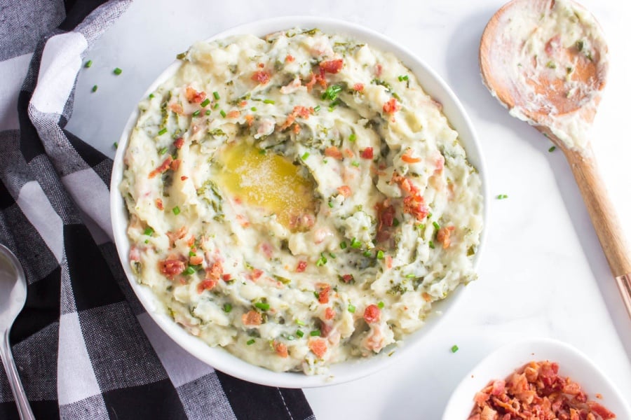 a white serving bowl full of Crockpot Colcannon Potatoes