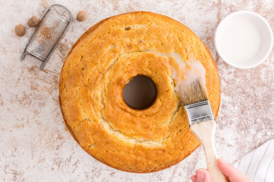 brushing glaze on to donut cake