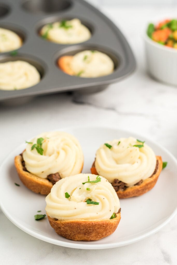 3 mini shepherd pies on a white plate