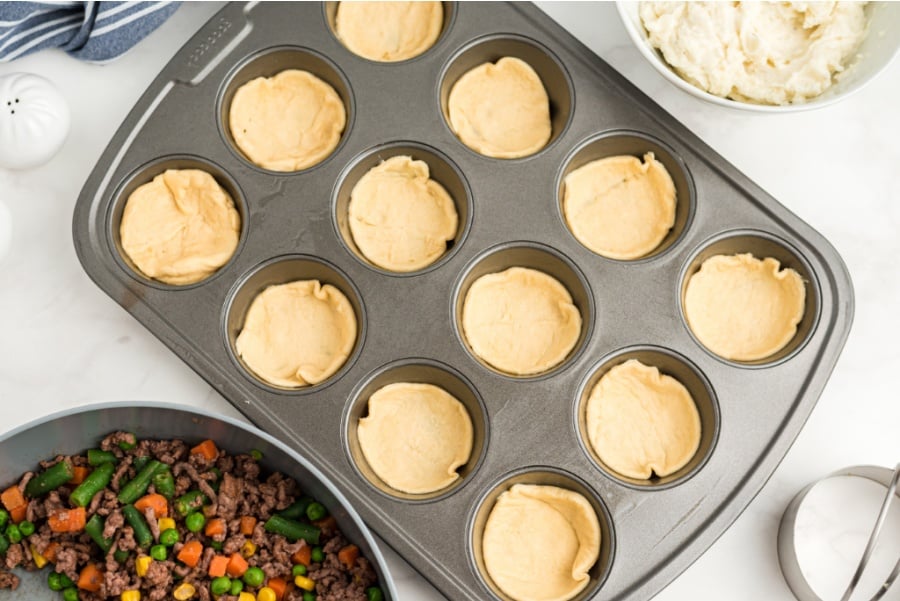 mini pie crusts in muffin tin openings