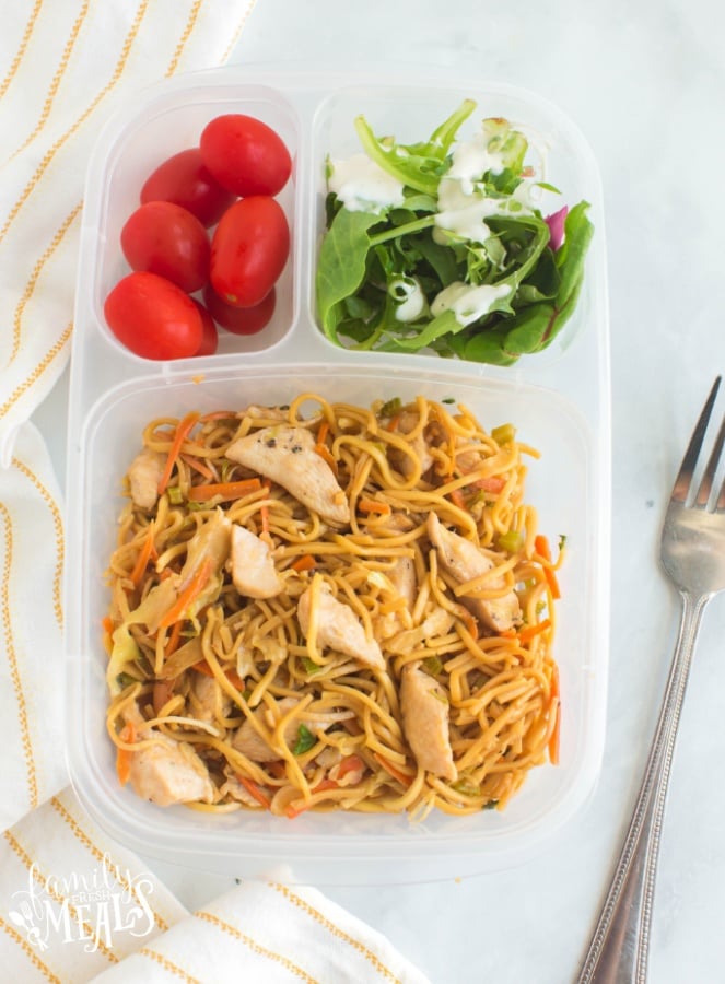 chicken chow mein in a lunchbox with a side salad and cherry tomatoes