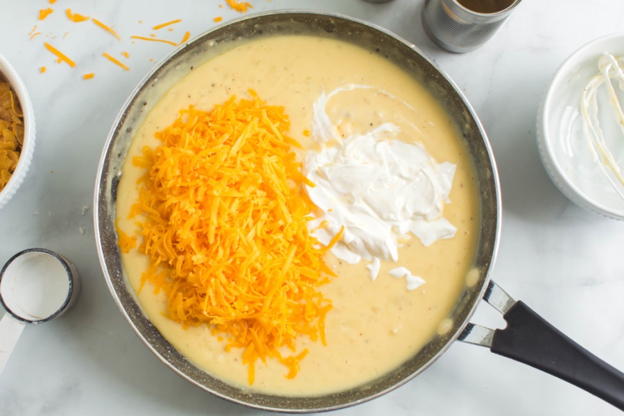 shredded cheese and sour cream added to pan