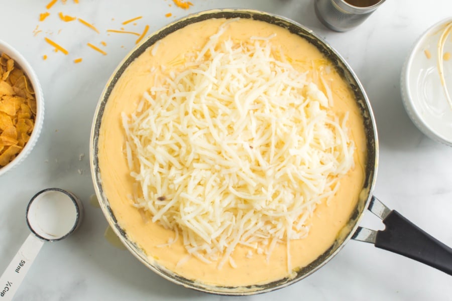 shredded cheesed added to the pan