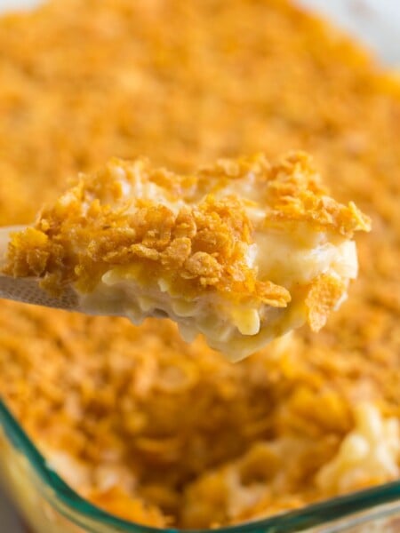 wooden spoon scooping up some Classic Cheesy Funeral Potatoes