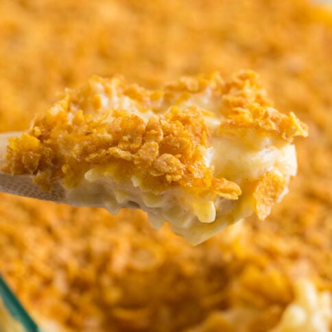 wooden spoon scooping up some Classic Cheesy Funeral Potatoes