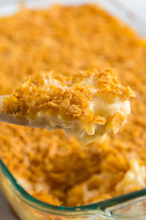 wooden spoon scooping up some Classic Cheesy Funeral Potatoes