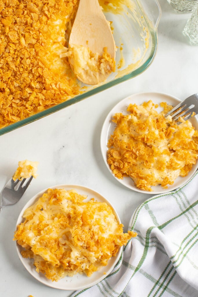 two plates of Classic Cheesy Funeral Potatoes