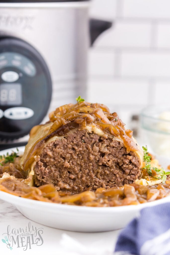 meatloaf on a serving platter with a slice removed