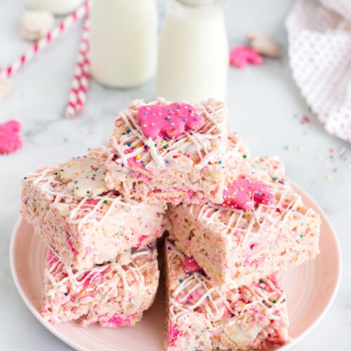 Circus Animal Cookie Rice Krispie Treats stacked on a white plate