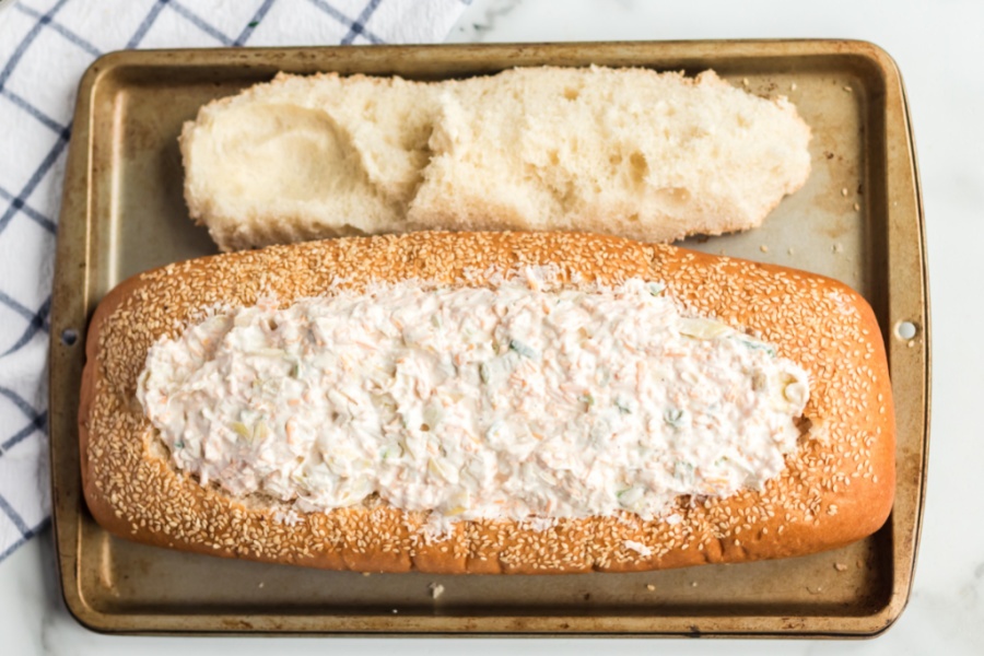 Mississippi Sin Dip inside loaf of bread, on a baking sheet