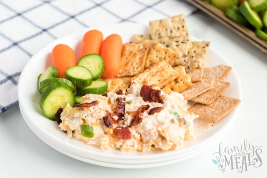 Mississippi Sin dip on a plate with vegetables and crackers 