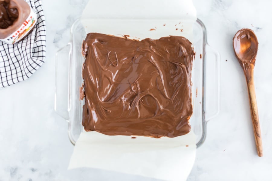 Nutella spread on to parchment paper in a baking dish